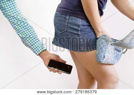 Sexual Harassment At Work. Man Taking A Photo With Mobile Phone Of Secretary's Butt