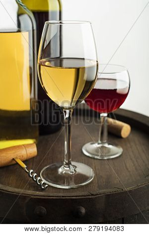 Glass And Bottle Of Red Wine And White Wine On Wooden Barrel