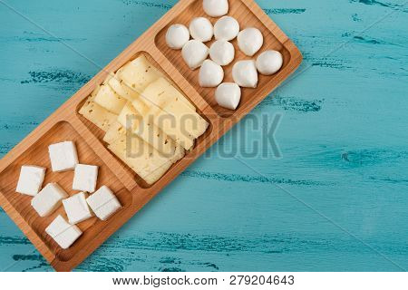 Cheese Compartmental Dish With Different Cheeses, On Rustic Wooden Background.