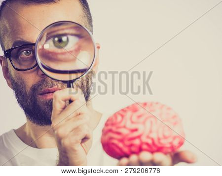 Adult Nerd Man Wearing Eyeglasses Looking At Human Brain Model. Thinking And Intelligence Conept