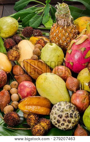 Summer Detox With Vegan Food. Assorted Thai Tropical Fruits On A Dark Wooden Rustic Background.
