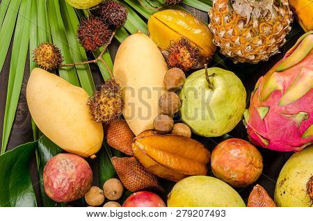 Summer Detox With Vegan Food. Assorted Thai Tropical Fruits On A Dark Wooden Rustic Background.