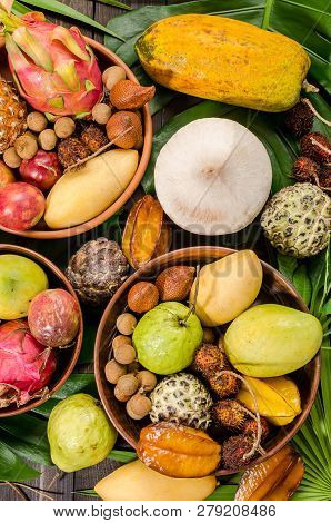 Summer Detox With Vegan Food. Assorted Thai Tropical Fruits On A Dark Wooden Rustic Background.