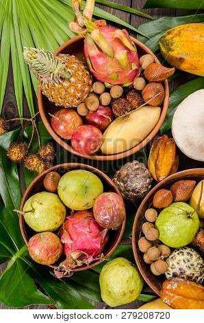 Summer Detox With Vegan Food. Assorted Thai Tropical Fruits On A Dark Wooden Rustic Background.