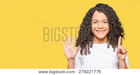 Young beautiful woman with curly hair wearing white t-shirt showing and pointing up with fingers number six while smiling confident and happy.