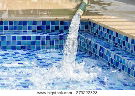 Filling The Pool With Artesian Water Flowing From The Pipe. Servicing