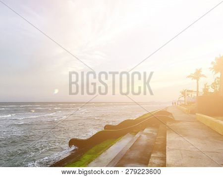 The Beach Of Paknampran With Cement Barrier And Sunlight And People As Background. Pranburi, Thailan