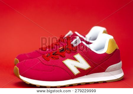 Boston, Ma, Usa, January 2019 - New Balance Nb 574 Athletic Shoes On Red Background. New Balance Ath