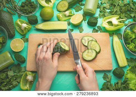 Healthy Green Vegan Cooking Ingredients. Flay-lay Of Female Hands Cutting Green Vegetables And Green