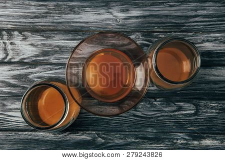 Top View Of Bottled Organic Tea On Wooden Table