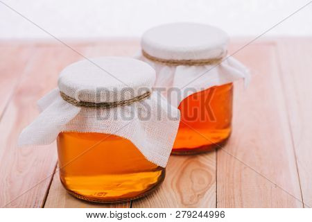 Selective Focus Of Bottled Fermented Tea In Jars Isolated On White