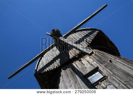 Lublin, Poland, August 2018: Old Wooden Windmill Against Blue Sky In Open Air Village Museum