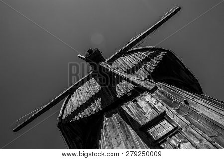 Lublin, Poland, August 2018, Old Wooden Windmill Against Sky In Open Air Village Museum, Monochrome