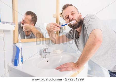 Funnny Guy Taking Care Of His Oral Hygiene, Brushing Teeth During Morning Bathroom Routine.