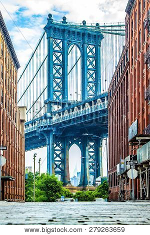 Manhattan Bridge Between Manhattan And Brooklyn Over East River Seen From A Narrow Alley Enclosed By