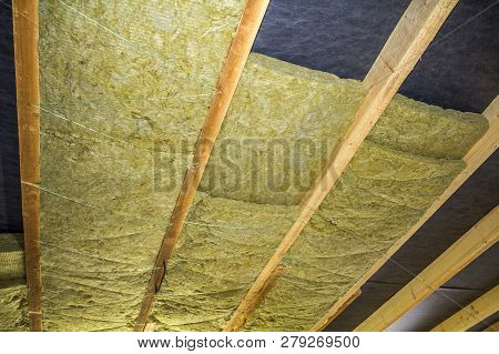 Thermal Insulation Mineral Rock Wool Installation At The New Building Attic Ceiling