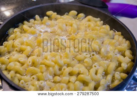 Pasta Is Cooked In A Black Cauldron Close Up, Home Made, Pasta Cooked In A Boiling Pot On The Stove 