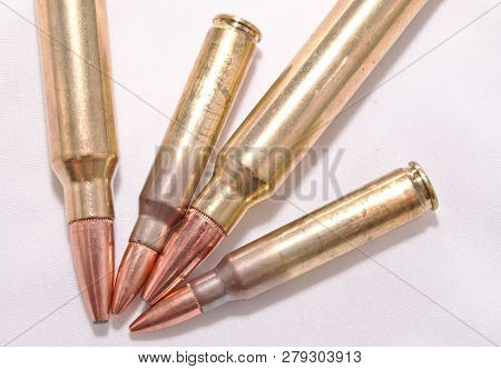 Four Rifle Bullets, Two .223 Caliber And Two .300 Winchester Magnum Caliber Showing The Tips On A Wh