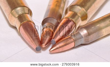 Four Rifle Bullets, Two .223 Caliber And Two .300 Winchester Magnum Caliber Showing The Tips On A Wh