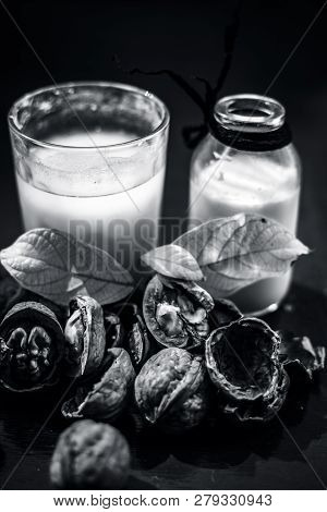 Close Up Of Akhrot Ka Dudh Or Walnut Milk On Wooden Surface With Raw Milk In  A Glass Bottle And Som