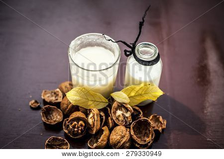 Close Up Of Akhrot Ka Dudh Or Walnut Milk On Wooden Surface With Raw Milk In  A Glass Bottle And Som