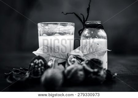 Close Up Of Akhrot Ka Dudh Or Walnut Milk On Wooden Surface With Raw Milk In  A Glass Bottle And Som