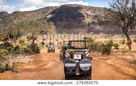 Tsavo East Reserve, Kenya - October 12, 2018: Safari Cars With Unindentified Tourists On Adventure T