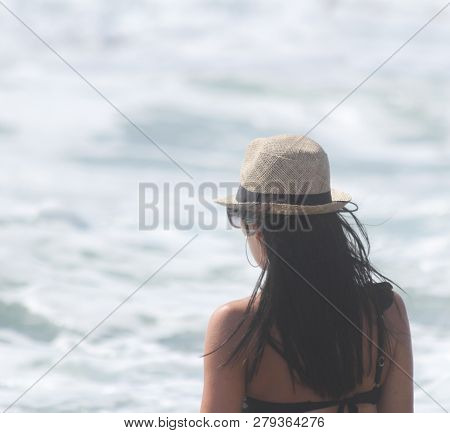 Beautiful Girl, Seen From Behind, With Hat Who Look The Sea. Sea In The Background. Sabaudia, Lazio,