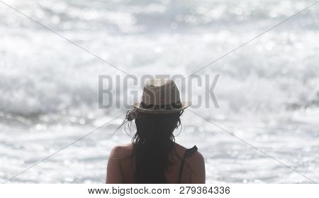 Beautiful Girl, Seen From Behind, With Hat Who Look The Sea. Sea In The Background. Sabaudia, Lazio,