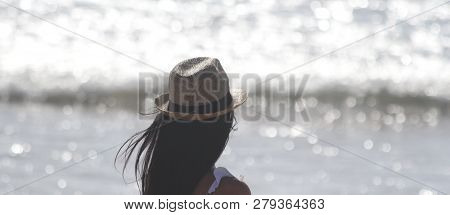 Beautiful Girl, Seen From Behind, With Hat Who Look The Sea. Sea In The Background. Sabaudia, Lazio,