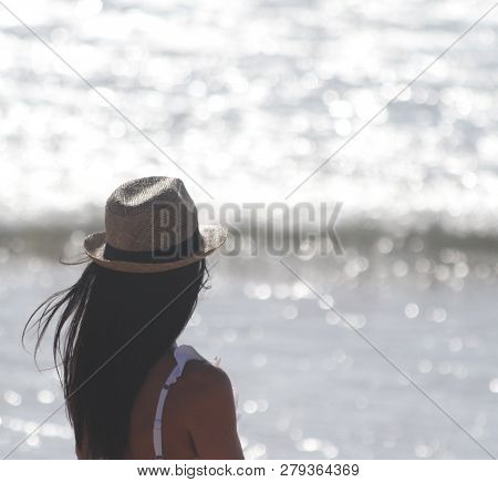 Beautiful Girl, Seen From Behind, With Hat Who Look The Sea. Sea In The Background. Sabaudia, Lazio,