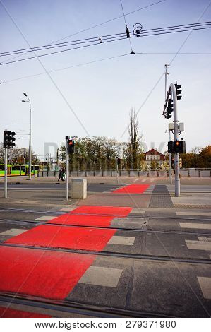 Poznan, Poland - November 1, 2018: Zebra Crossing With Red Marked Bicycle Path And Red Lights On The