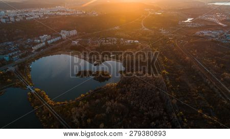 Lake Within City Park Under The Sunset Warm Light.