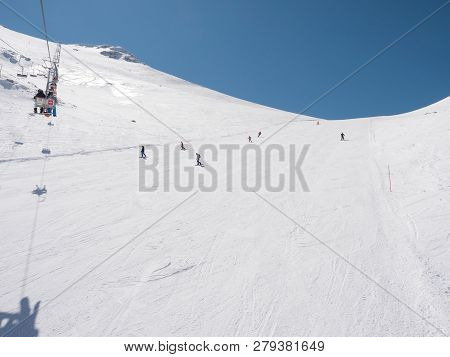 Skiers And Snowboarders In A Slope