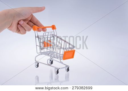 Hand Holding A Cart On A White Background