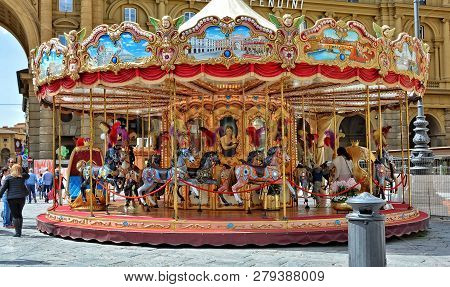 Beautiful Carousel. Tourists Relax At The Republic Square In Florence. Arcone Triumphal Arch. Landma