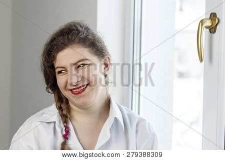 Young Woman 30 Years Old. Smiles At Us. Going To Repair The Handle On The Glass
