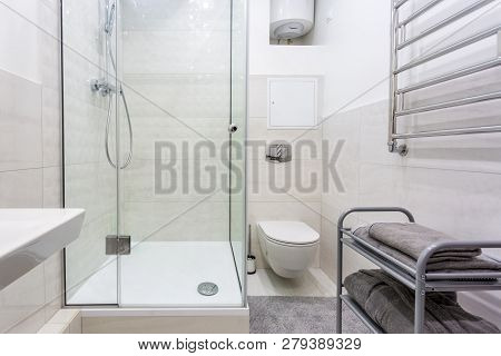 Toilet And Detail Of A Corner Shower Cabin With Wall Mount Shower Attachment