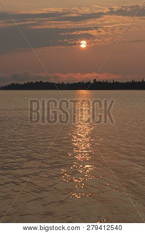 Sunrise Over A Distant Island In The North Woods On Saganaga Lake In Quetico Provincial Park