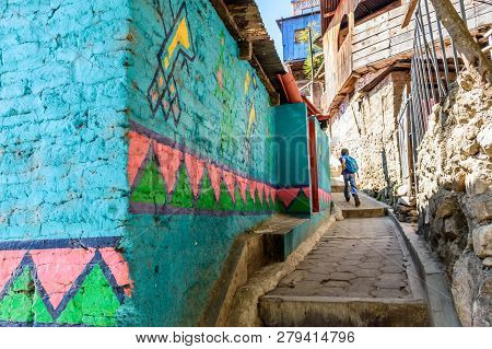 Santa Catarina Palopo, Lake Atitlan, Guatemala - December 29, 2018: Boy Runs In Alleyway In Village 