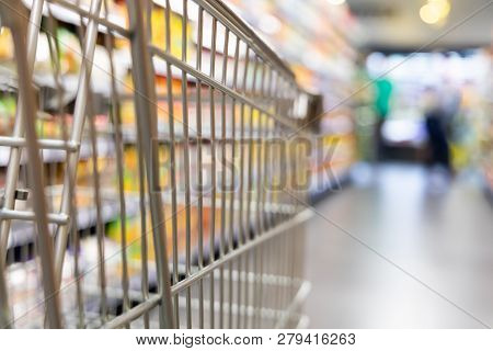 Shopping Trolley Cart With Shallow Dof Against Supermarket Aisle Background