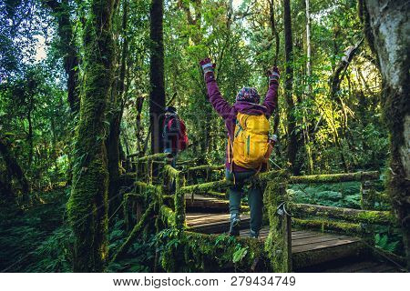 Couples Traveling, Relax In Winter.enjoy Hiking Walking Travel To Study Nature In The Rainforest. At