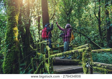 Couples Traveling, Relax In Winter. Walking Travel To Study Nature In The Rainforest. At The Angka, 