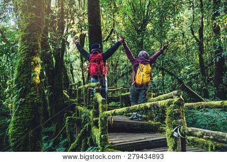 Couples Traveling, Relax In Winter. Walking Travel To Study Nature In The Rainforest. At The Angka, 