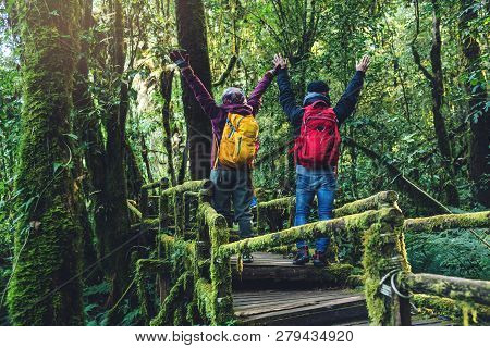 Couples Traveling, Relax In Winter. Walking Travel To Study Nature In The Rainforest. At The Angka, 