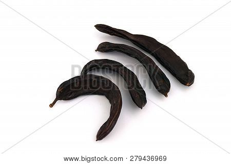 Carob On White Ground, Dry Carob
Locust Bean On A White Background,
Carob On A Plate, On A White Bac