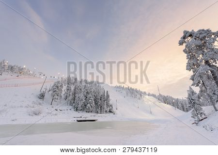 Rukatunturi Ski Jumping Hill In Winter Season And Nice Weather And Blue Sky In Winter Season And Sun