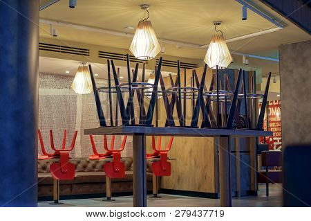 Upside Down Chairs In Interiour Of Closed Cafe