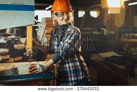 Middle Aged Woman Working With A Drill In Workshop With Copy Cpace. Concept Of Woman In A Male-domin