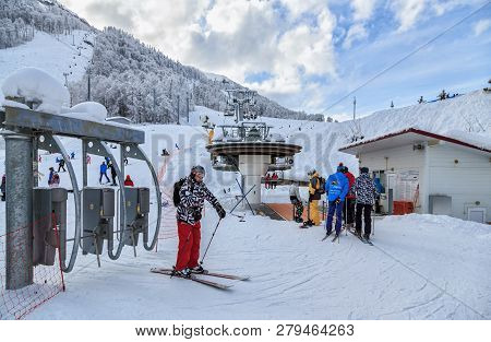 Sochi, Russia - January 9, 2015: A Skier Has Passed A Turnstile For Boarding Onto A Chair Ski Lift I
